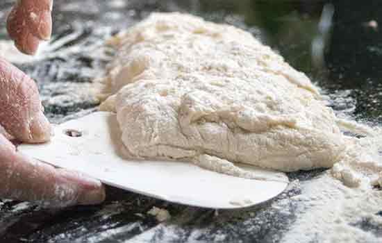 Mit der Teigkarte das Br&ouml;tchen auf das Blech setzenn